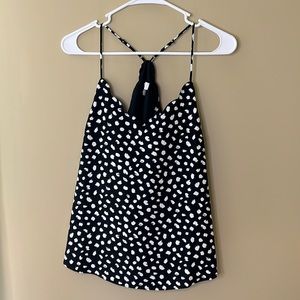Sleeveless black and white polka dot blouse